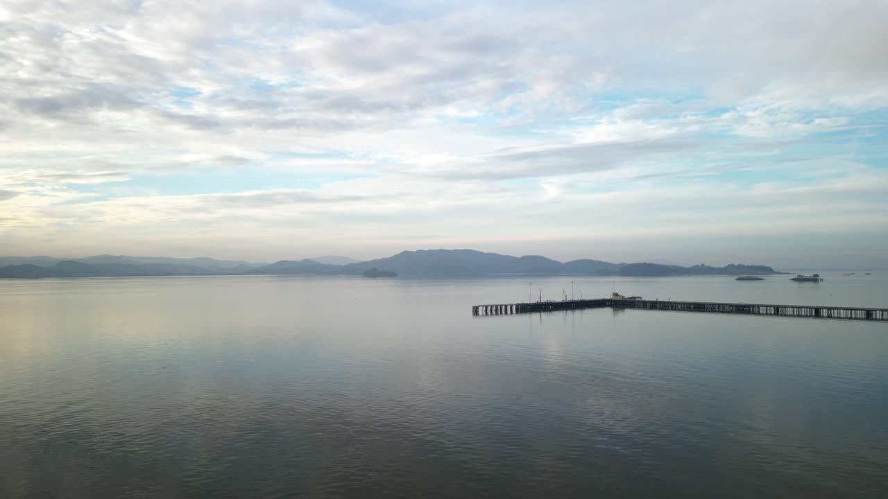 Stunning aerial overview of reflecting water below piers with distant mountains, Point Molate Beach Richmond California USA