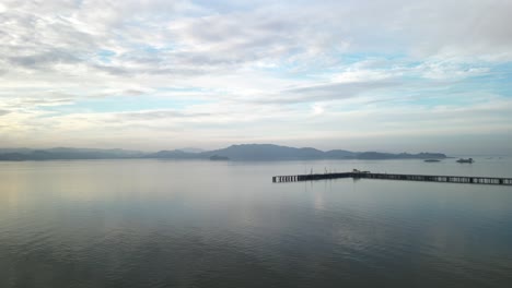 stunning aerial overview of reflecting water below piers with distant mountains, point molate beach richmond california usa