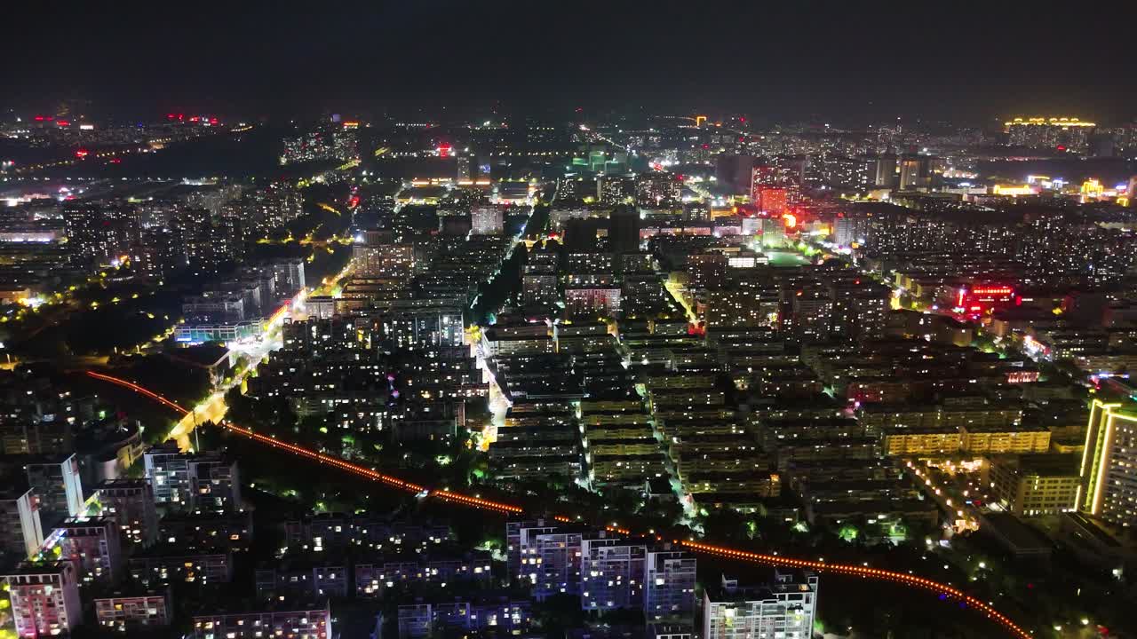 Nighttime drone shot of Liaocheng city skyline in Shandong Province, China.