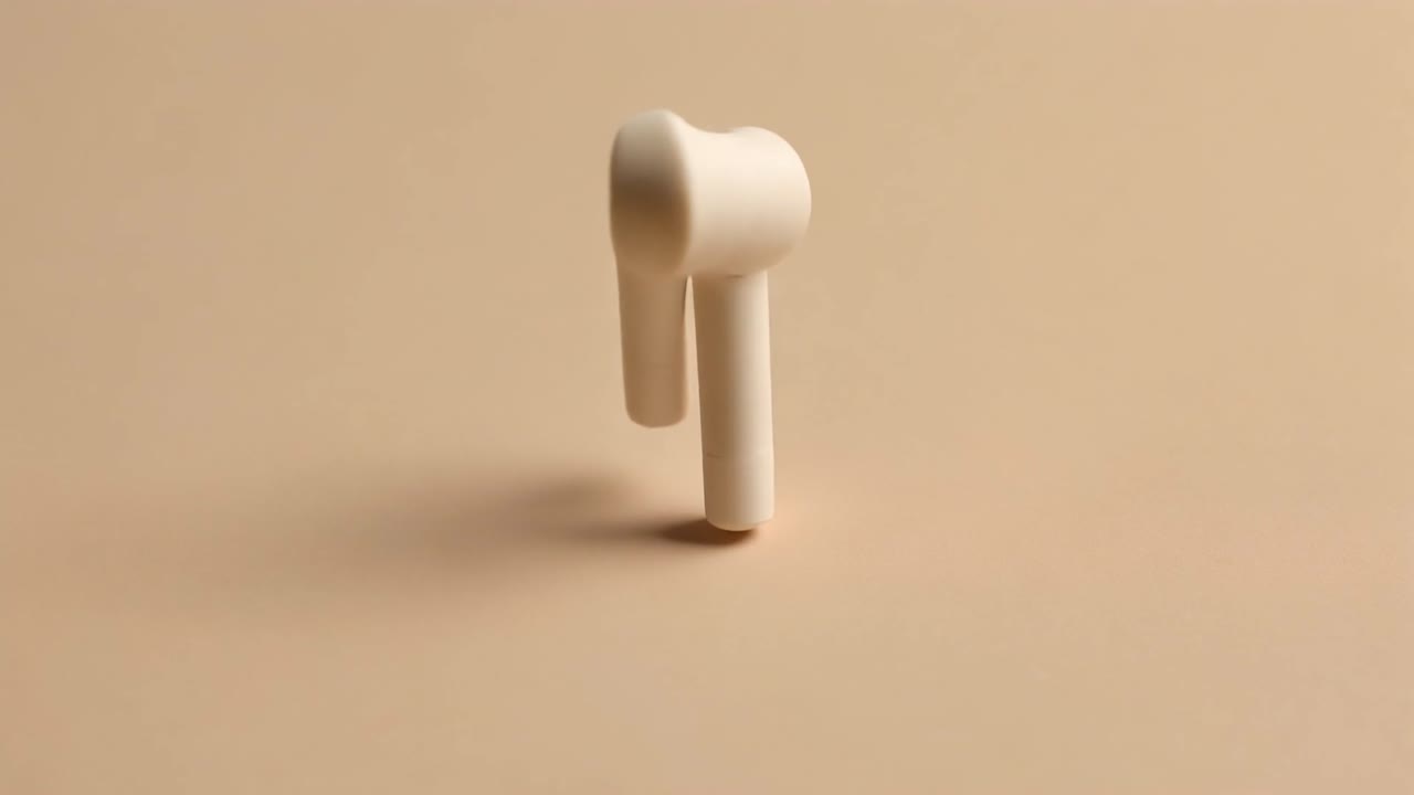 White Wireless Earbuds Connecting Magnetically on Beige Background