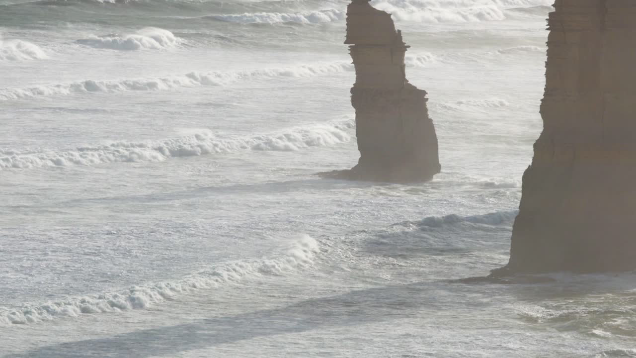 A serene view of the Twelve Apostles with gentle waves and soft morning light, capturing the natural beauty of Australia's coastline