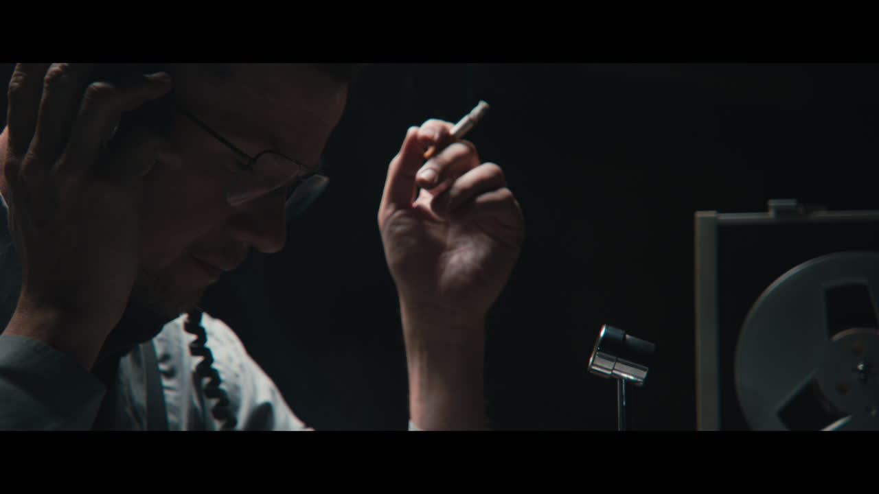 An intelligence officer listens to the wiretap recordings