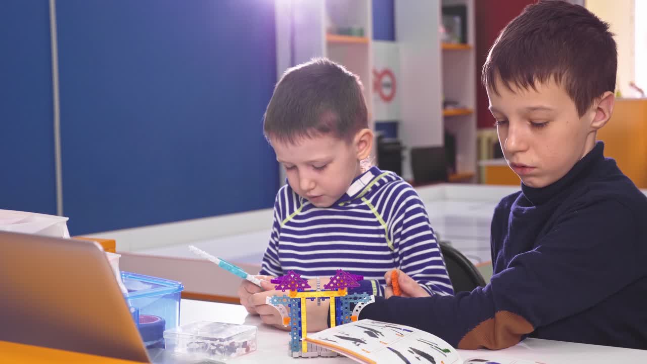 Boys Building with Robotics Toys in Classroom