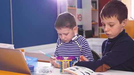 boys building with robotics toys in classroom