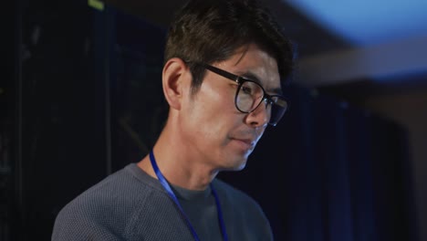 portrait of asian male it technician checking computer server