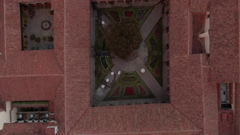 4k aerial view over a beautiful decorated inside garden of a spanish colonial house in the city centre of cusco, capital of the incas