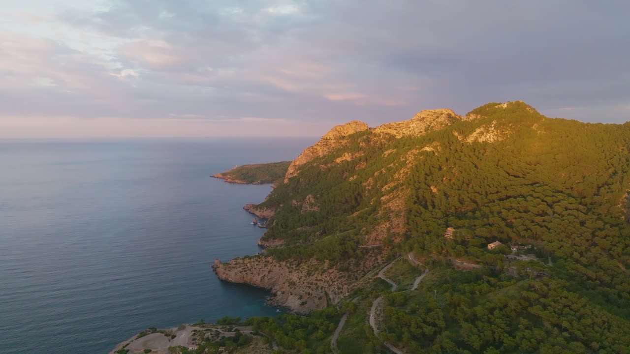 Drone flight on the coast of Mallorca overlooking the area of Bahia de Pollenca with spectacular sunset light