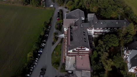aerial view of the alpin hotel in the spa and ski village of grafschaft in the sauerland region near winterberg against a blue sky with clouds