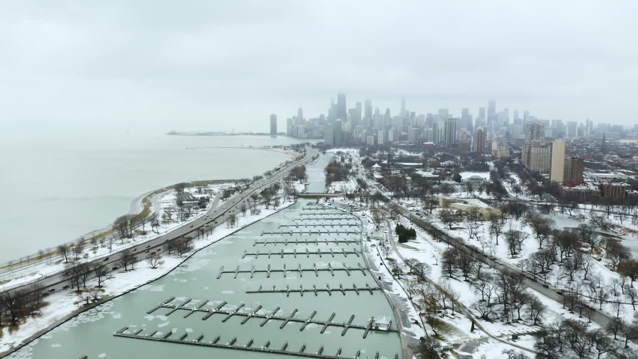 Aerial Descent on Boat Harbor with Downtown Chicago in background during Cold Winter day