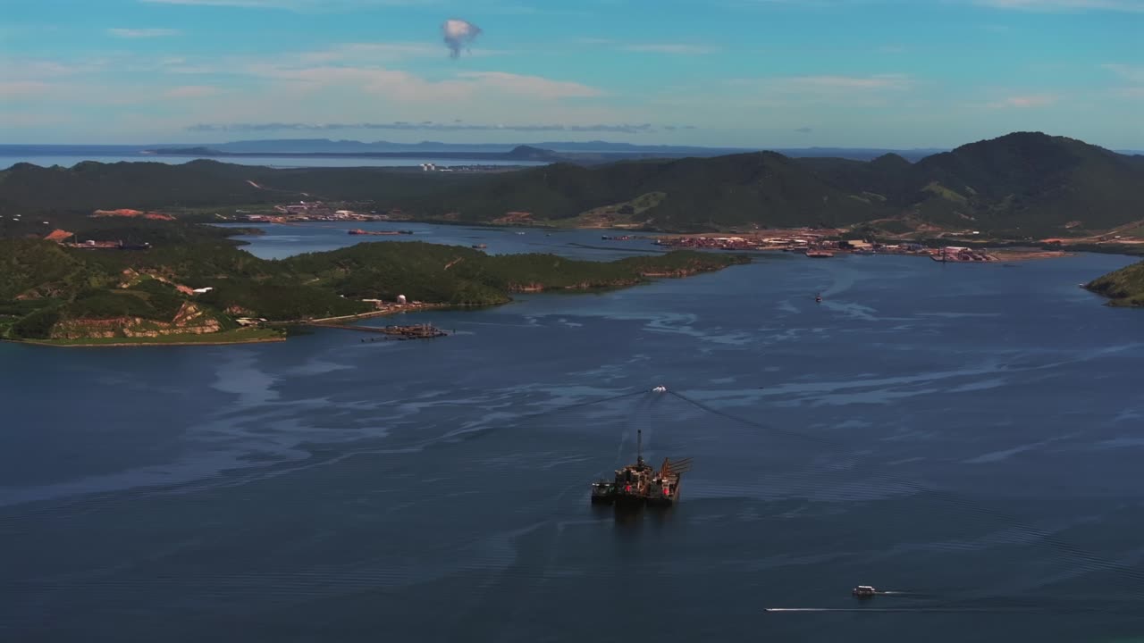 Ela Beach Port Moresby Papa Papua New Guinea Aerial drone oil rig boat blue sky stunning sunny morning bay coastline hills PNG Capital City fishing wharf Harbor Idlers Bay circle left
