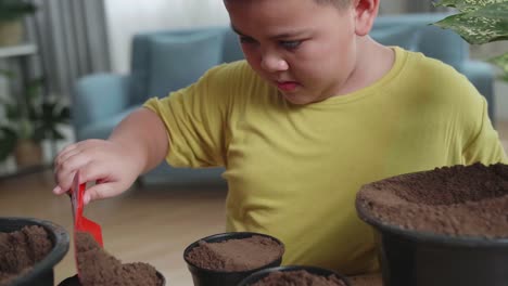 child planting potted plants