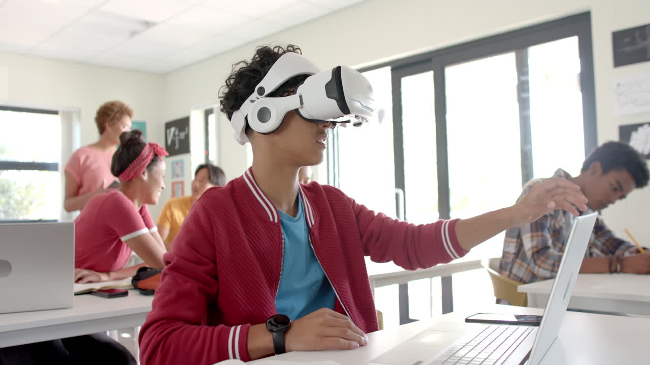 Using VR headset, teenager in high school classroom interacting with virtual environment