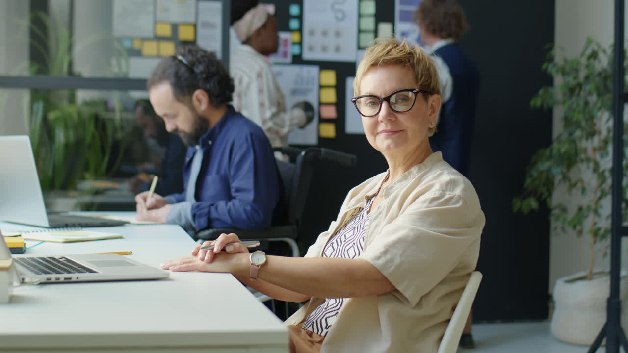 Portrait of Businesswoman at Workplace in Office