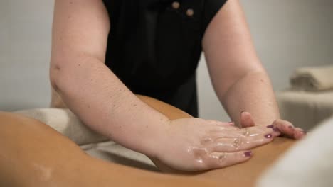 masseuse performing relaxing leg massage