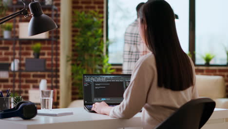 professional asian software engineer is working remotely typing code on a laptop