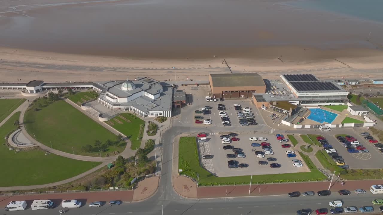 High above the Marine Hall Fleetwood and Fitness centres by the sea, with car parks and road. Lancashire, UK.