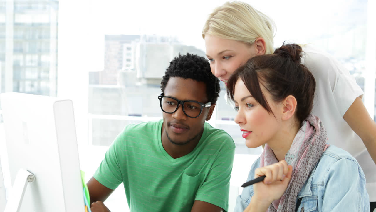 Blonde creative designer helping her colleagues 