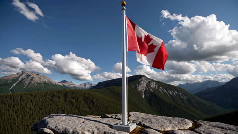 canadian flag on mountain summit