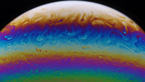 close-up footage of the colourful surface of a soap bubble