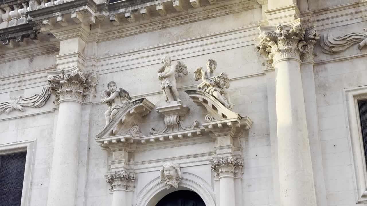 Cinematic view of the front facade of St Blaise's Church in Dubrovnik Old Town captured in the early morning at sunrise [travel b-roll]