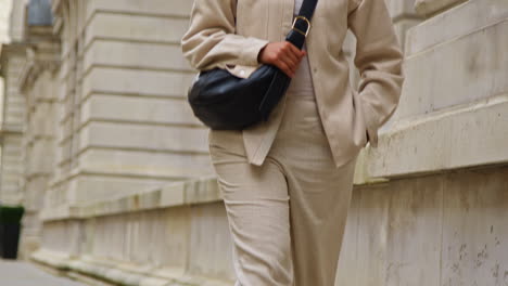 portrait of muslim businesswoman wearing hijab with modern business suit walking to work past city office buildings 1