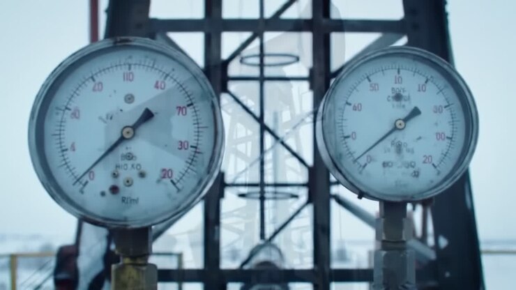 Exploring the Mechanisms of Oil Extraction: A Detailed Look at Pumpjacks and Pressure Gauges in a Cold Environment