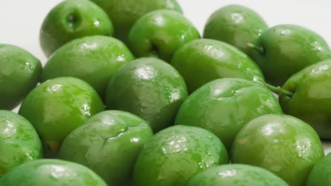 pickled round green olives from greece as background, top view. high quality 4k footage