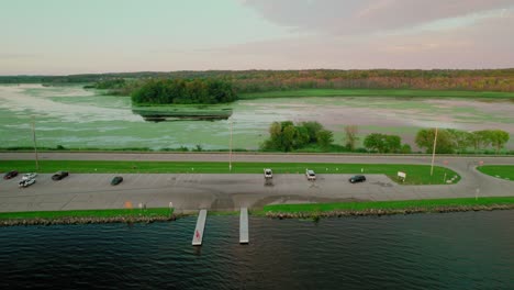 aerial view of a calm lake with a boat launch at sunset