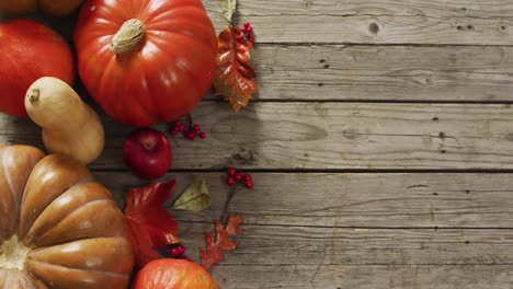 video of pumpkins and autumn leaves on wooden background