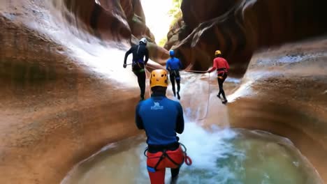 canyoneering adventure through a red rock canyon
