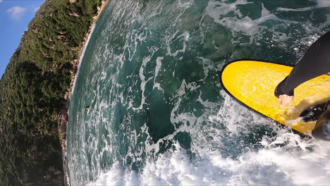 beautiful coastal scene with surfer surfing and falling into sea