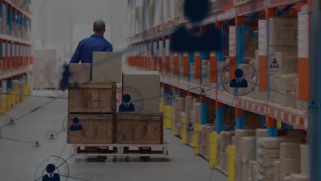 Network-of-profile-icons-against-rear-view-of-senior-male-worker-pulling-a-pallet-at-warehouse