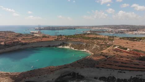 Aerial-drone-video-from-eastern-Malta,-Marsaxlokk-area,-Il-Hofra-l-Kbira-bay