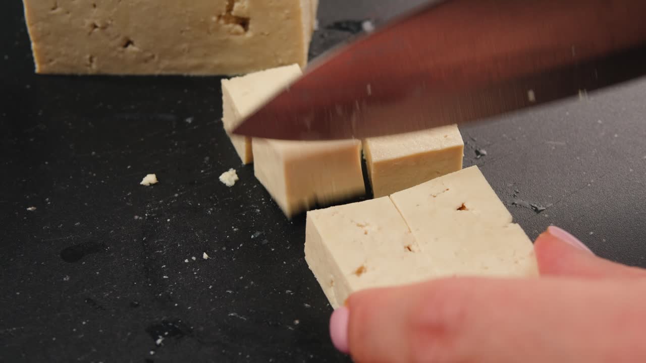 Cutting tofu on a cutting board
