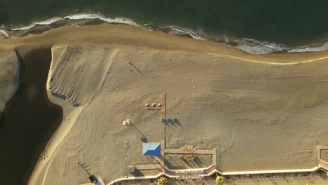 Static-high-angle-aerial-shot-of-a-beach-during-sunrise