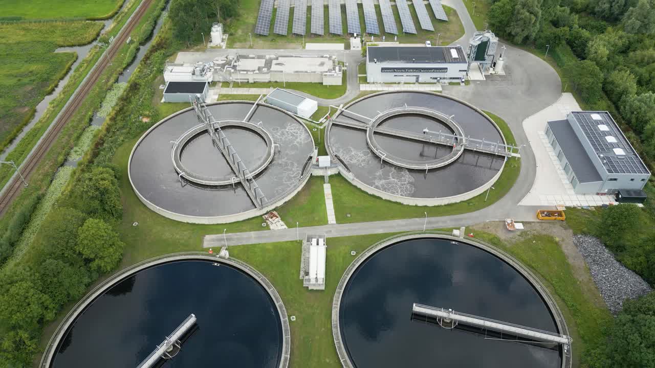 Perfectly aligned drone perspective of circular sedimentation tanks at a wastewater facility near Alphen aan den Rijn