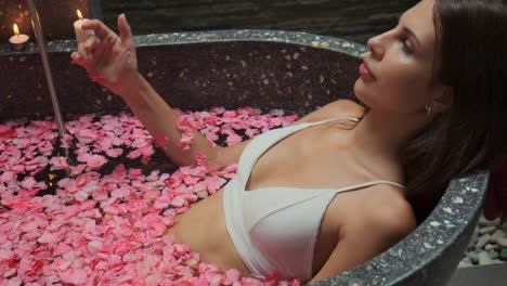 woman relaxing in a rose petal bath