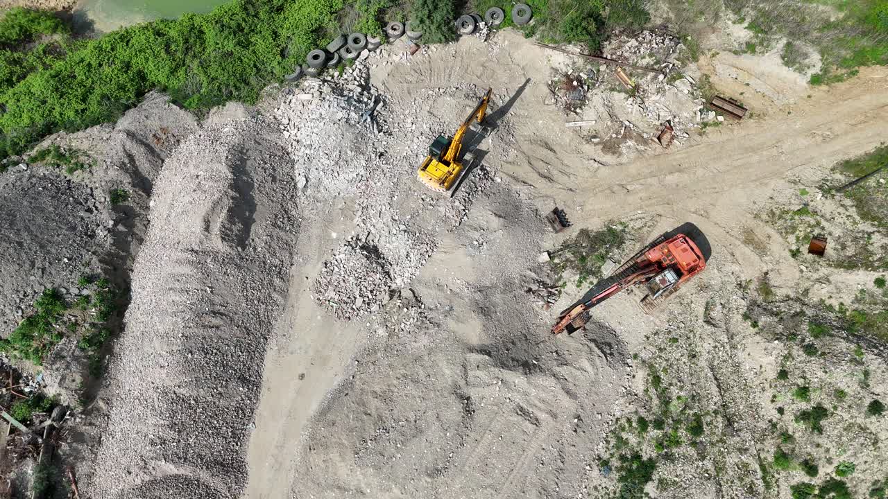 Excavator , diggers Overhead birds eye drone aerial view in quarry Essex UK