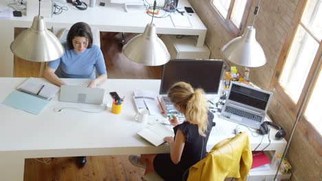 businesswomen working at desk in new office