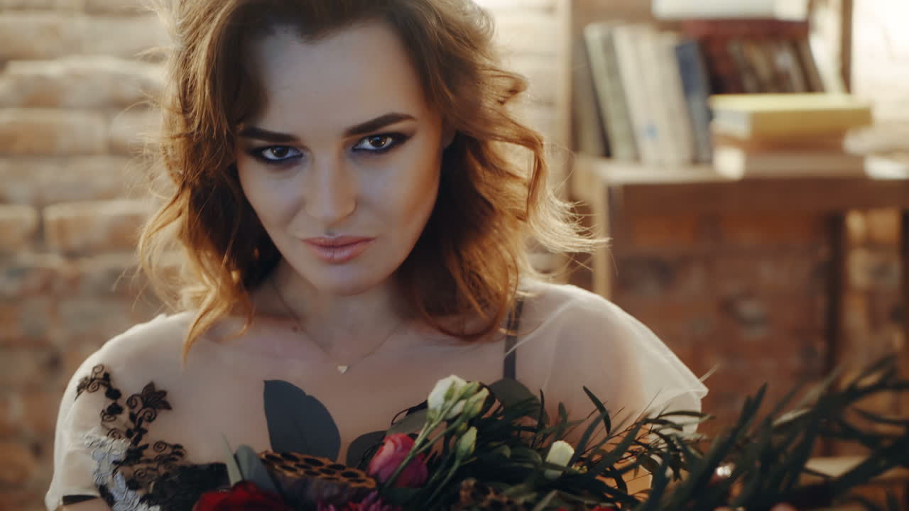 Witch at table. Portrait of woman dressed in witch style sitting by the table