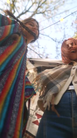 two women wearing colorful ponchos