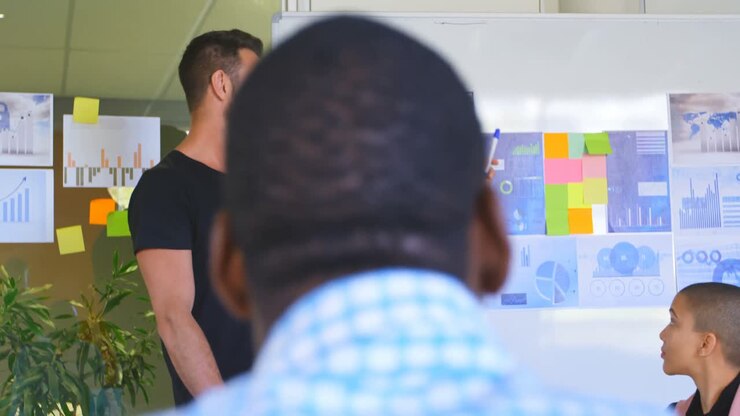 Young mixed race business team planning and sitting in modern office 4k