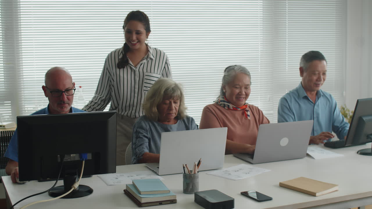 Teacher Checking Senior Students Progress on Computer Class