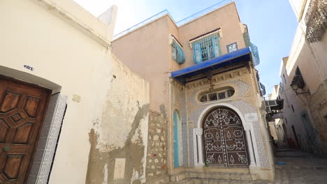 a beautiful traditional tunisian building with detailed designs in a narrow historic alleyway