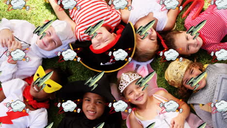 rocket and cloud icon moving against kids in costumes sleeping in the garden