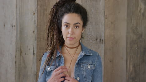 portrait of beautiful young hispanic woman looking pensive cute playful female wearing stylish denim fashion dreadlocks hairstyle