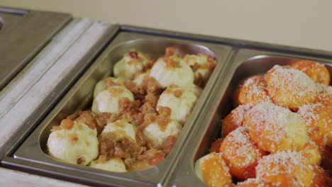 buffet with various dishes in a self-service restaurant. slider shot