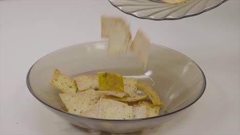 pouring crispy snacks into a bowl