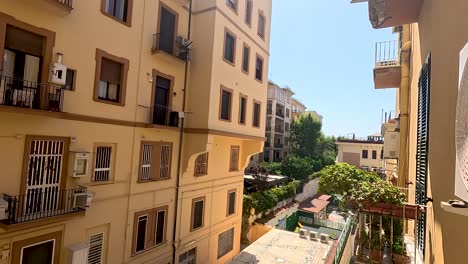 yellow building with balconies and greenery