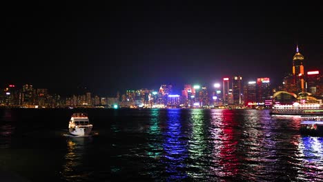 boats and city lights reflecting on water